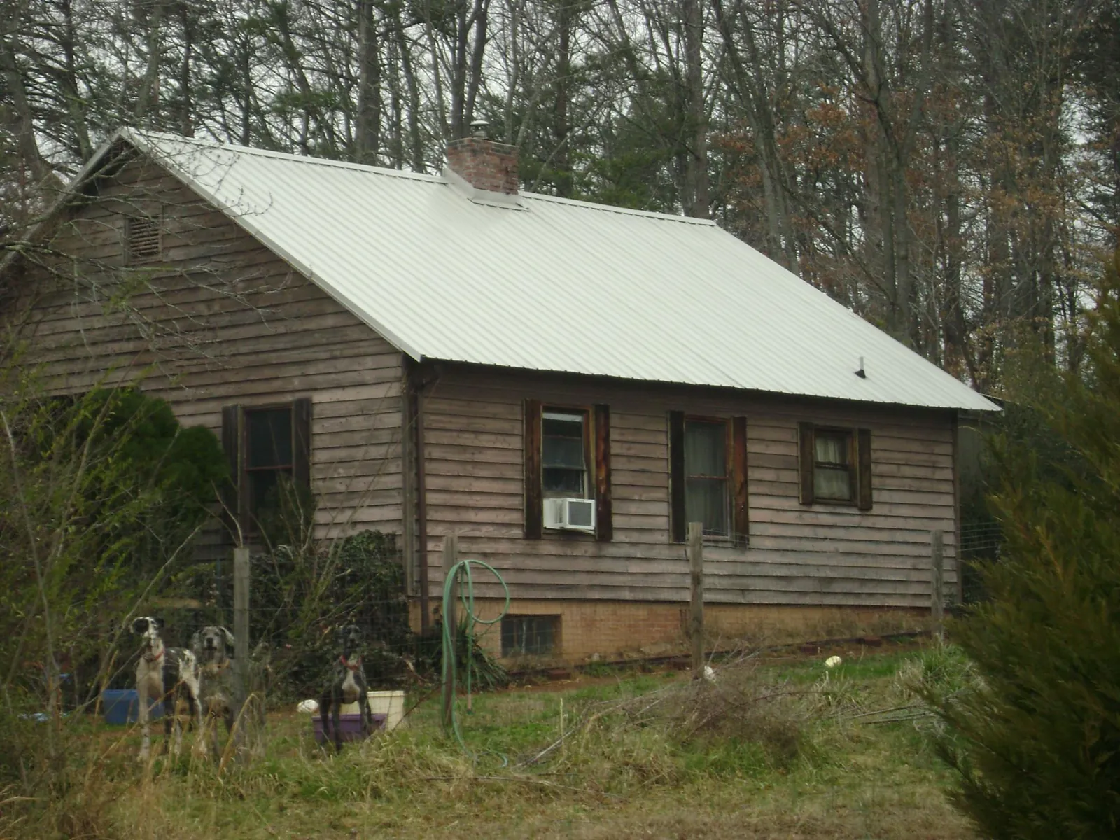 White metal roof on an old wood sided farmhouse, from a Metal Roof Installation job in Cape May